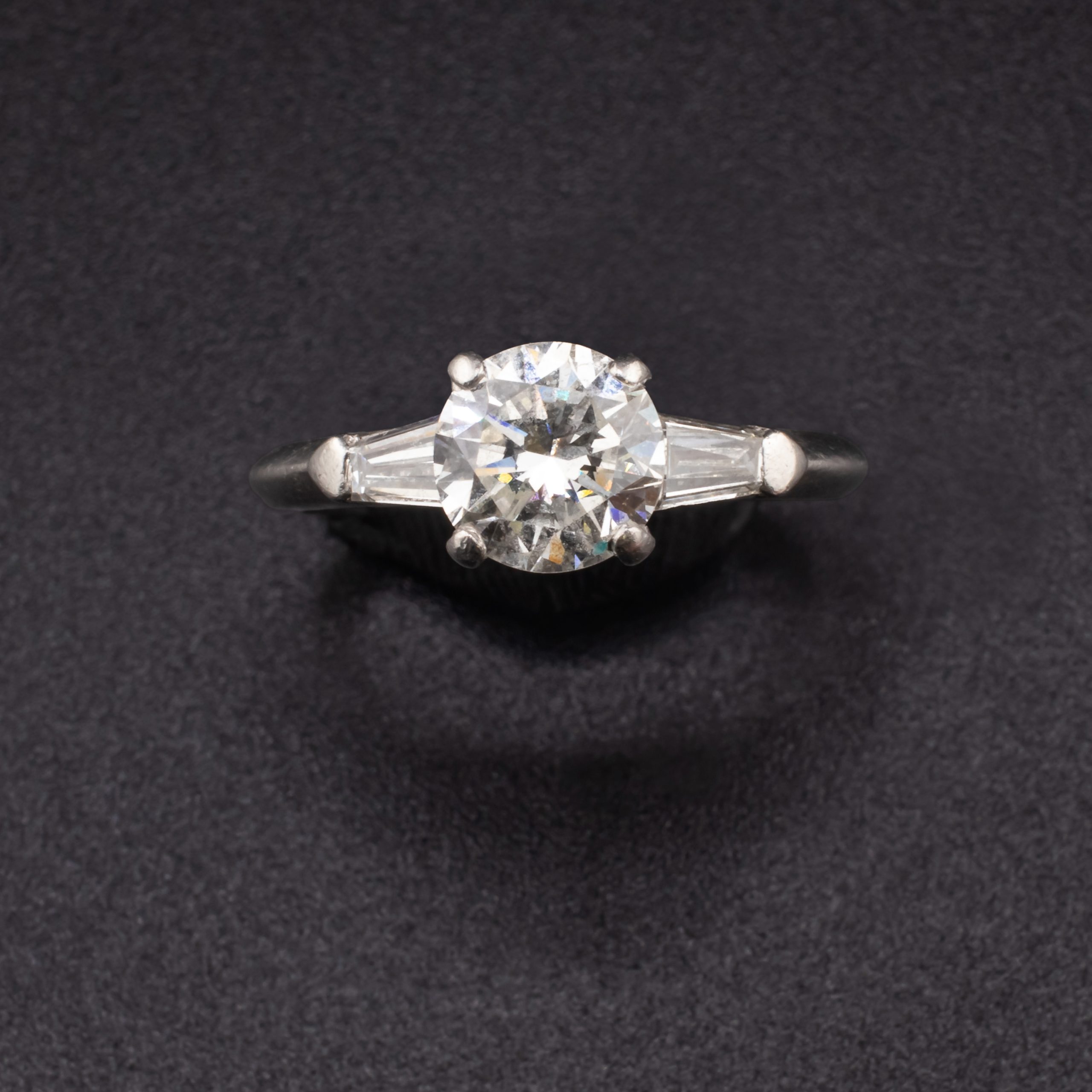 Mid Century Round 0.88 Carat Diamond Solitaire Set in Iridium Platinum with Two Tapered 0.2 Carat Baguette Diamonds attributed to Shreve & Company Jewelers - Image 2