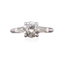 Mid Century Round 0.88 Carat Diamond Solitaire Set in Iridium Platinum with Two Tapered 0.2 Carat Baguette Diamonds attributed to Shreve & Company Jewelers