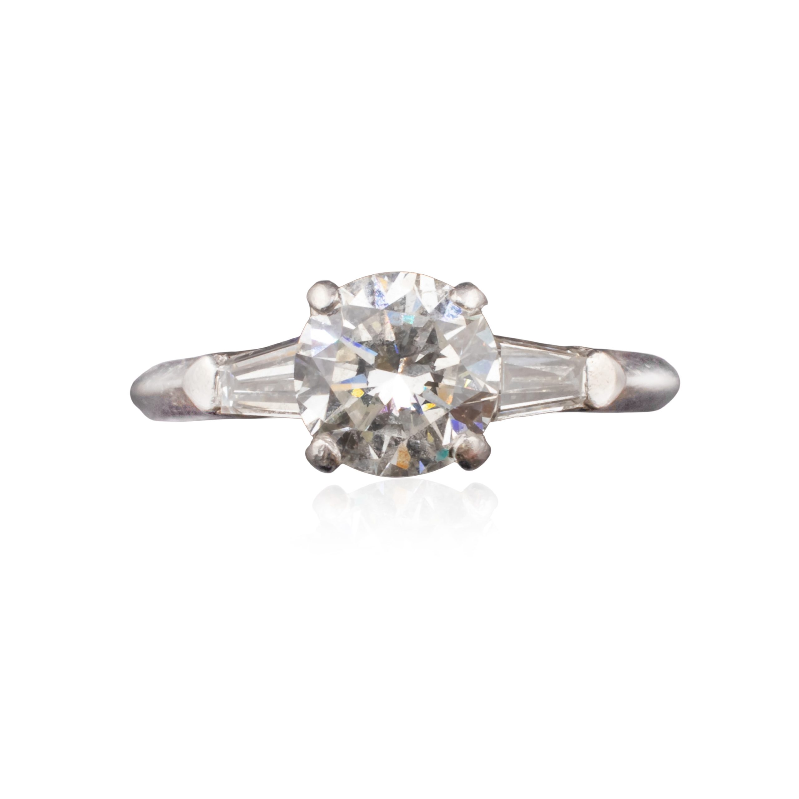 Mid Century Round 0.88 Carat Diamond Solitaire Set in Iridium Platinum with Two Tapered 0.2 Carat Baguette Diamonds attributed to Shreve & Company Jewelers