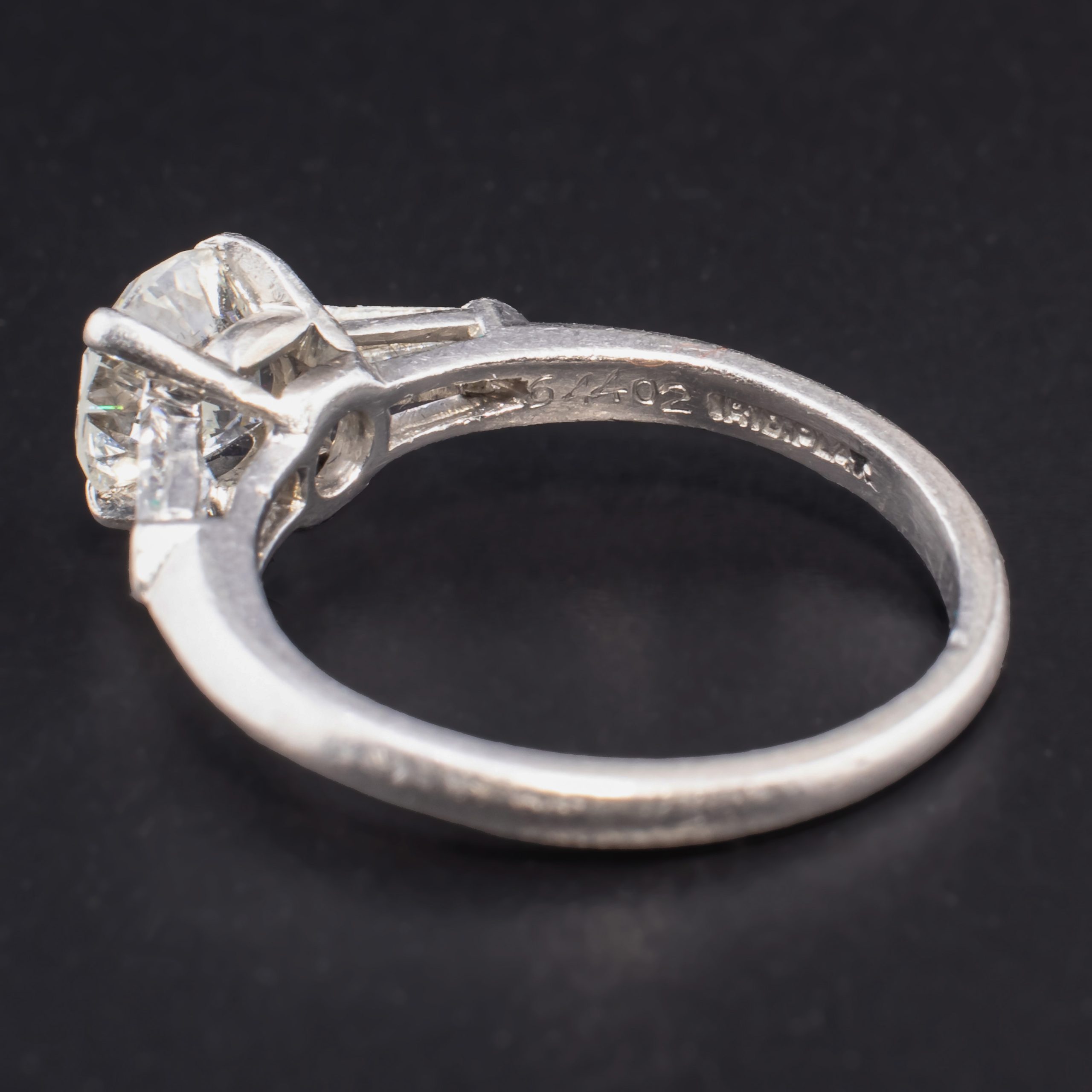 Mid Century Round 0.88 Carat Diamond Solitaire Set in Iridium Platinum with Two Tapered 0.2 Carat Baguette Diamonds attributed to Shreve & Company Jewelers - Image 5