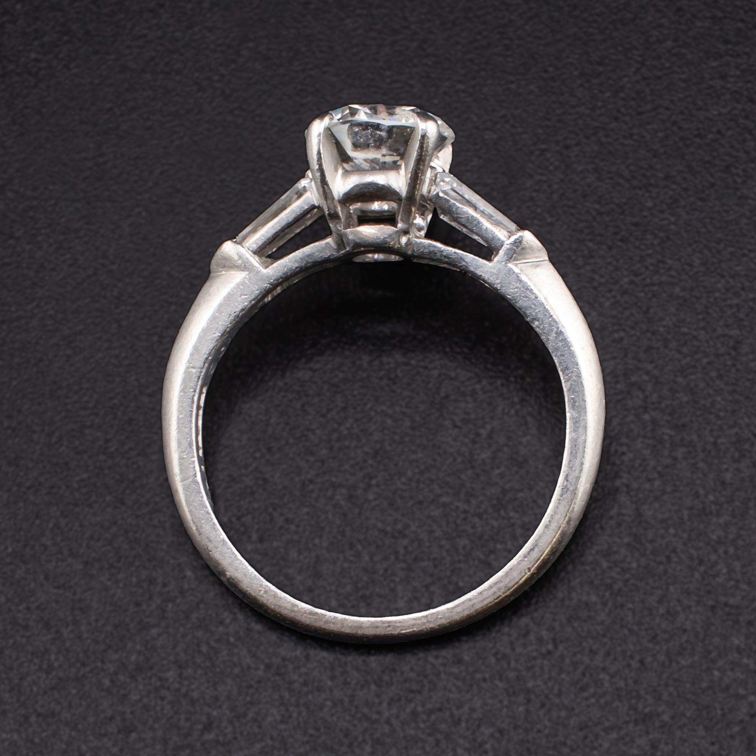 Mid Century Round 0.88 Carat Diamond Solitaire Set in Iridium Platinum with Two Tapered 0.2 Carat Baguette Diamonds attributed to Shreve & Company Jewelers - Image 3